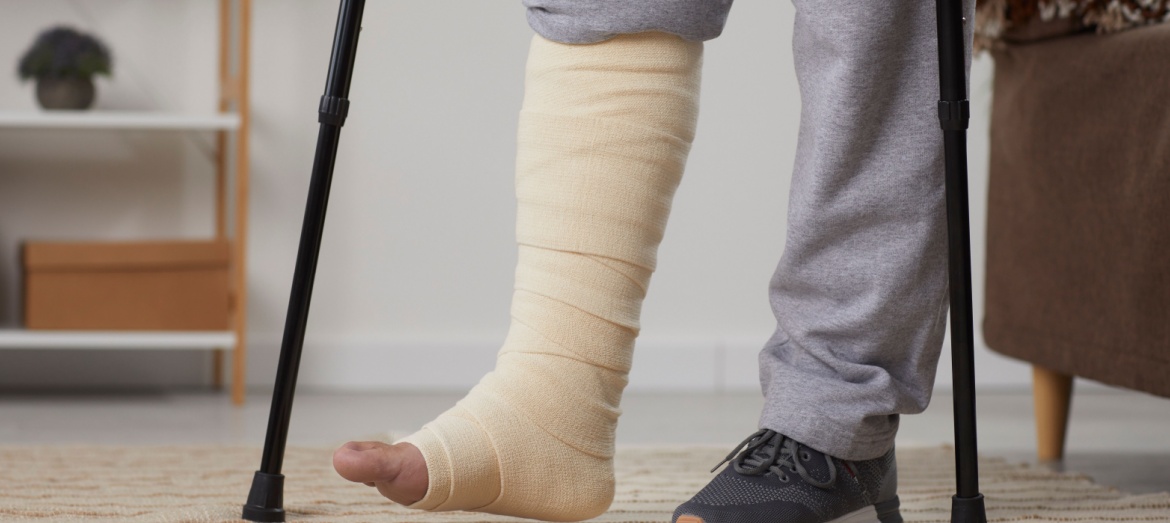 A man with a broken leg using crutches.