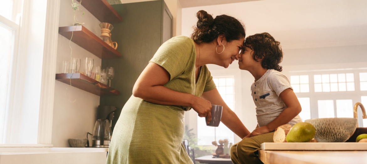 A woman and her child in the kitchen.