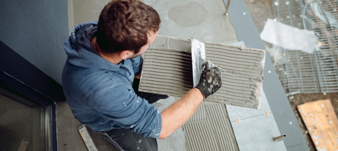 A man installing tiles.