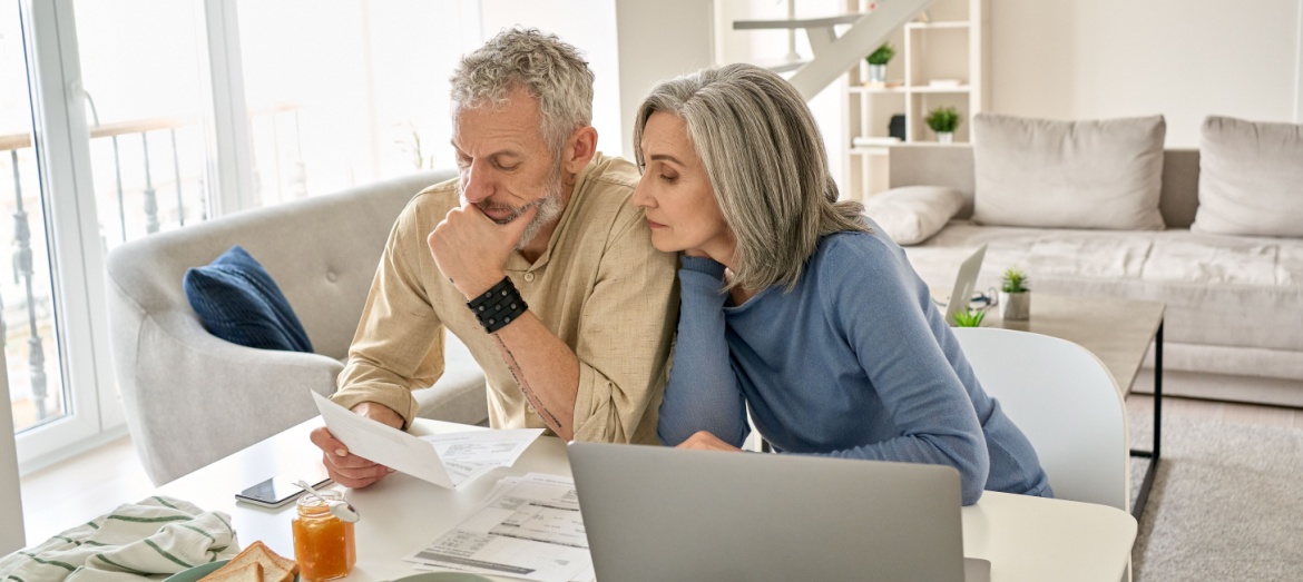 A couple looking at paperwork together in their home.