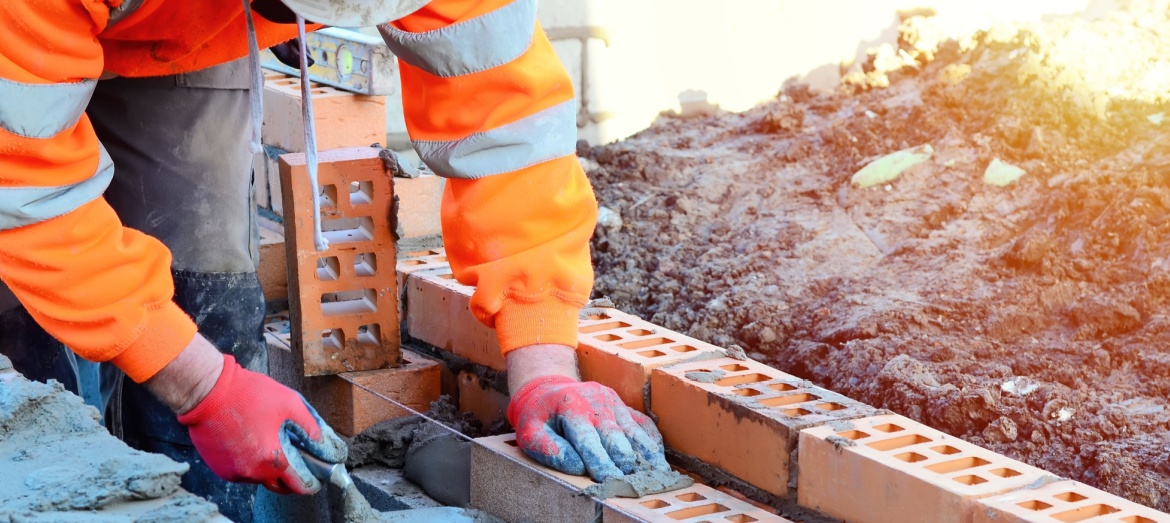 A bricklayer working on a construction site.