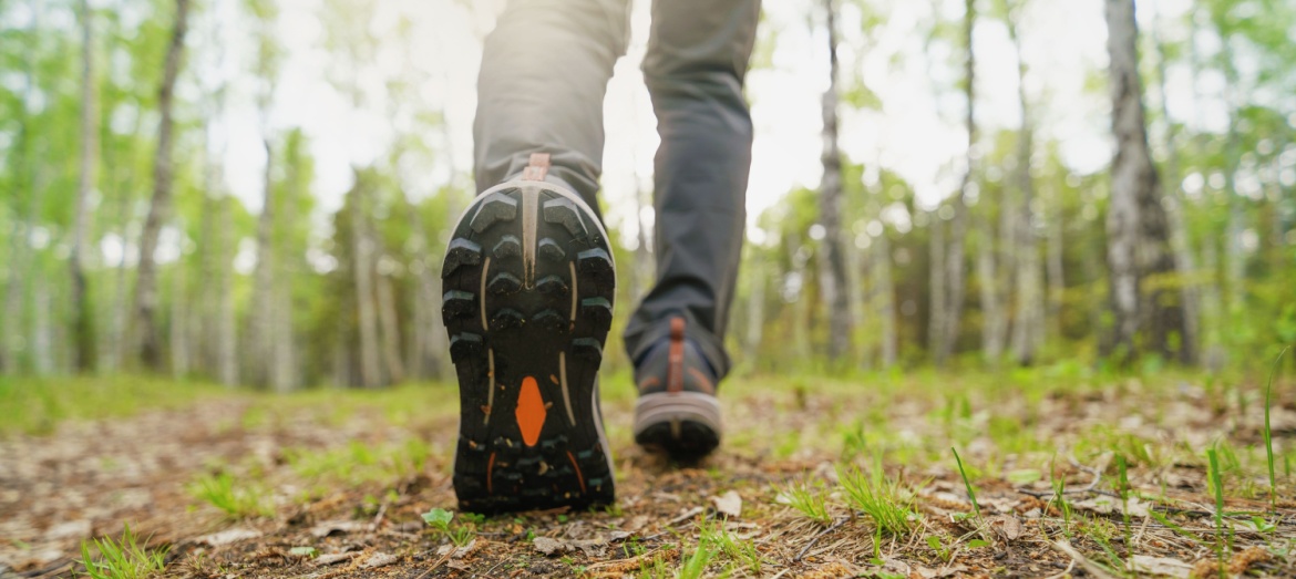 A close-up of a person walking in the woods.