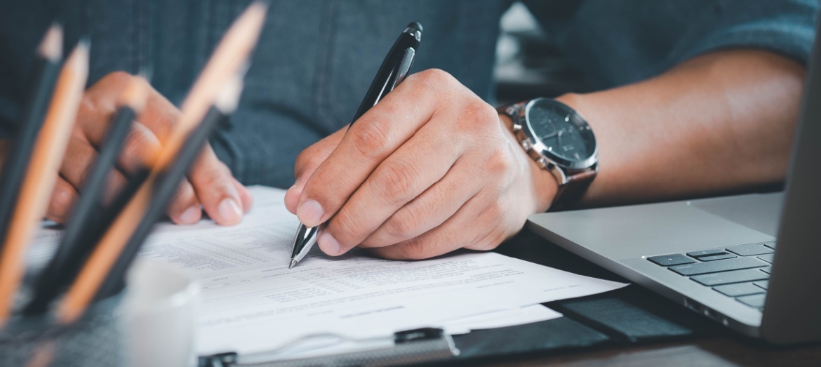 A man making notes on paperwork.