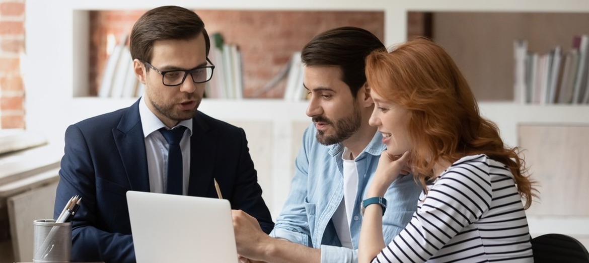A couple speaking to a mortgage adviser.