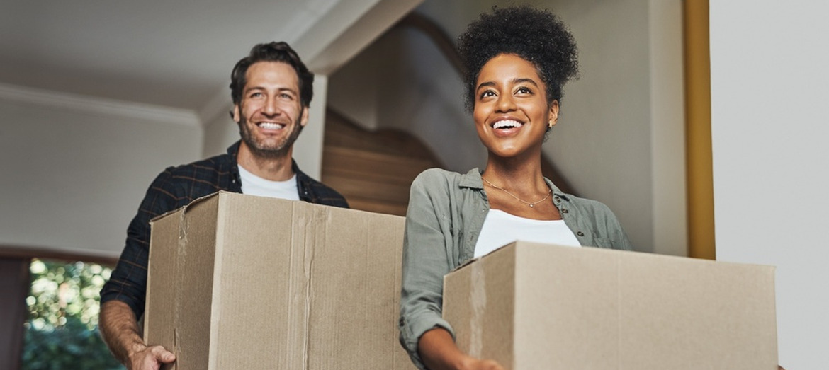 A young couple moving into their home.