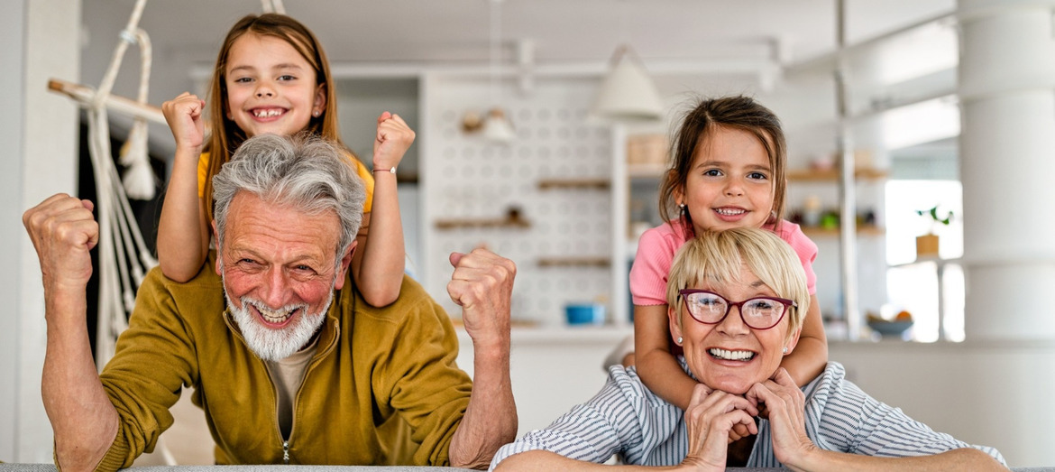 Grandchildren and grandparents having fun together in their kitchen