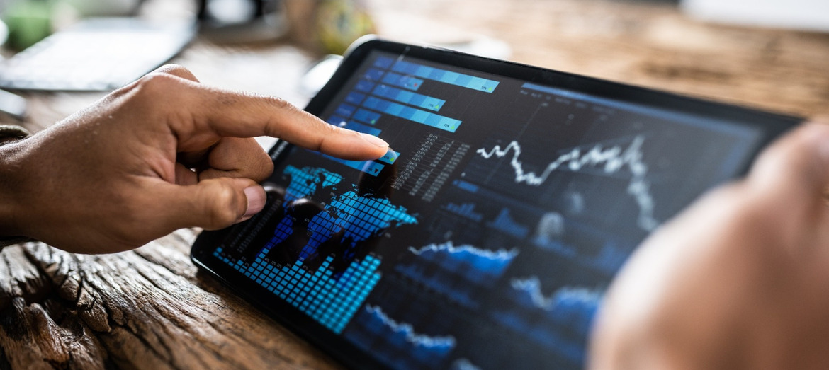 A person reviewing investment performance on a tablet.